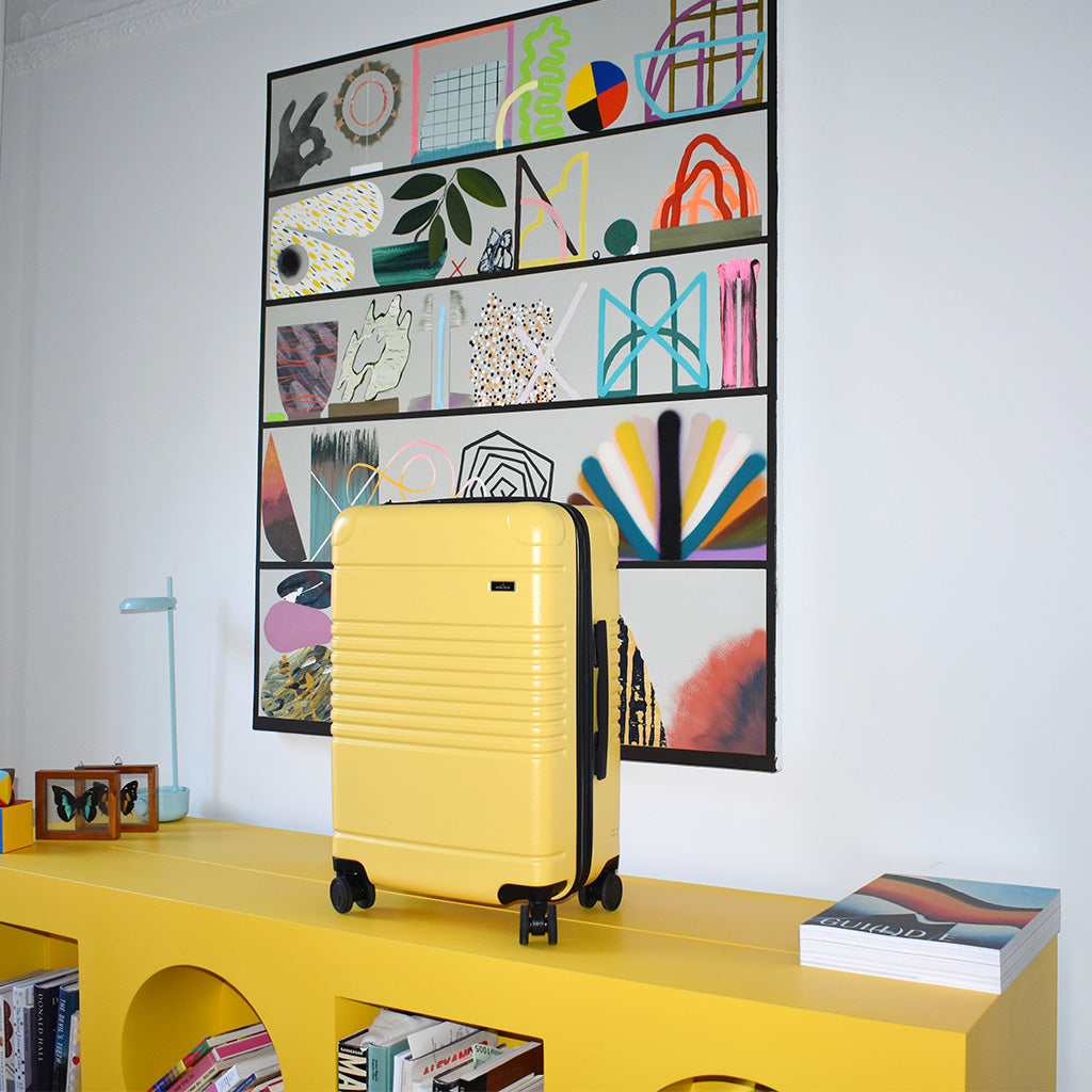 lemon zipper carry-on max standing on bookshelf