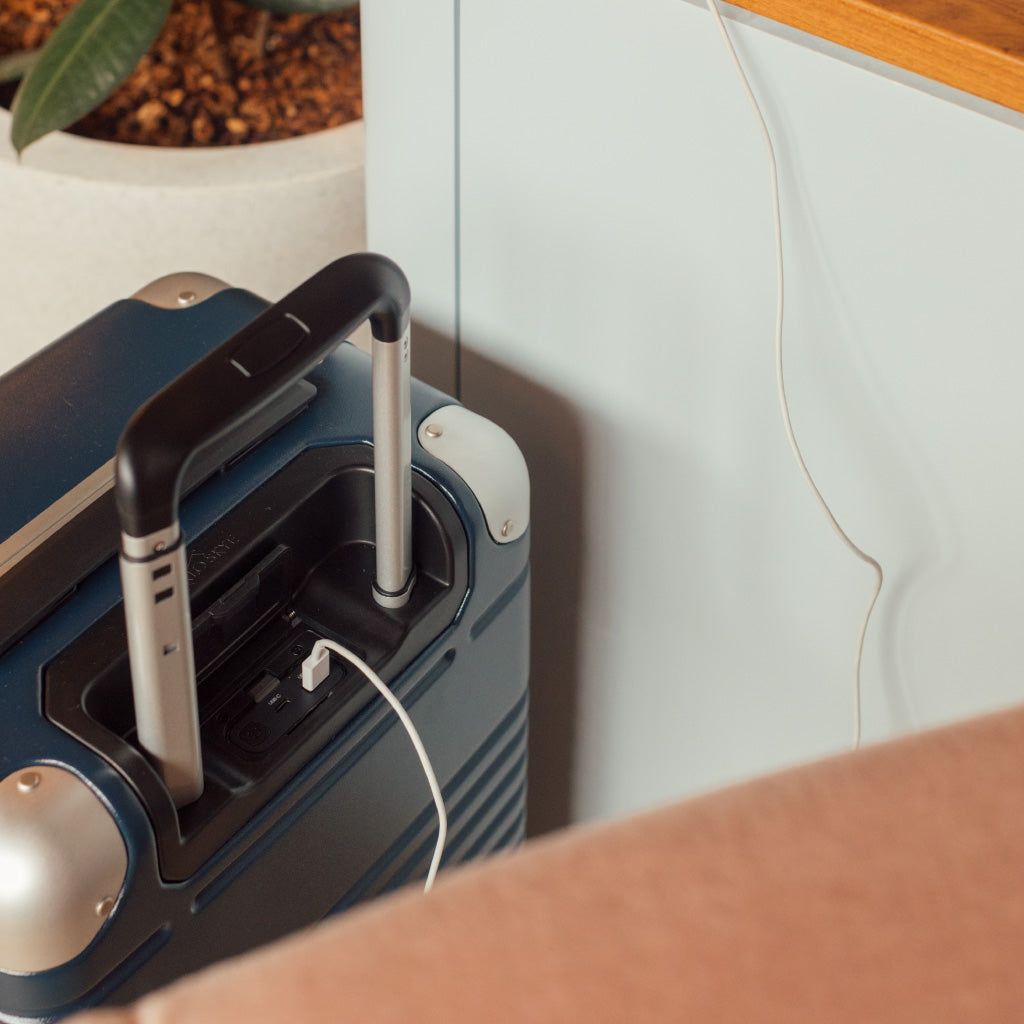 removable power bank visible in navy frame carry-on