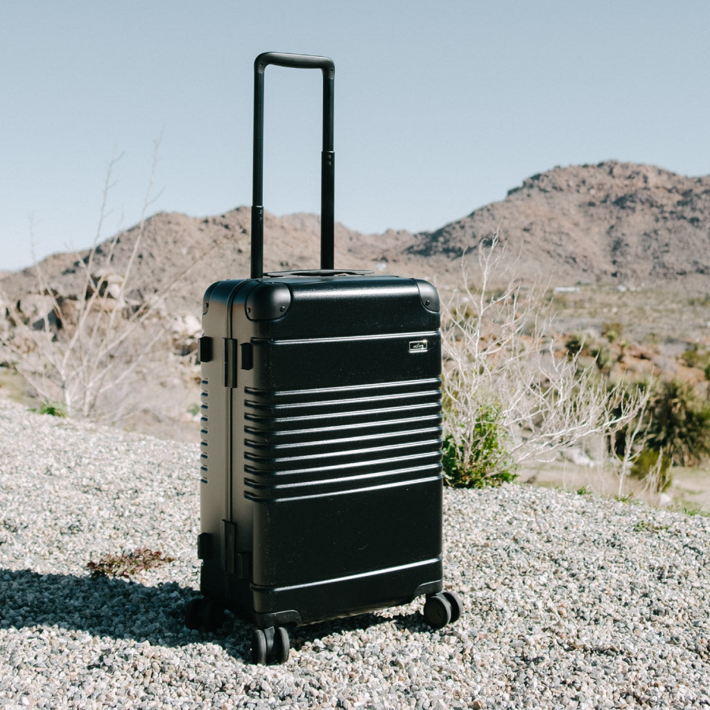 black frame carry-on in the desert