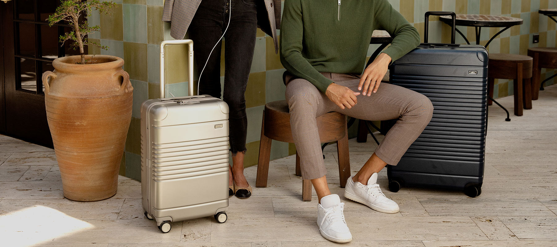 man and woman next to each other surrounded by luggage