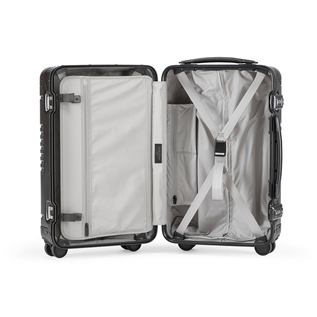 Open frame carry-on in black aluminum edition showing the interior of both sides