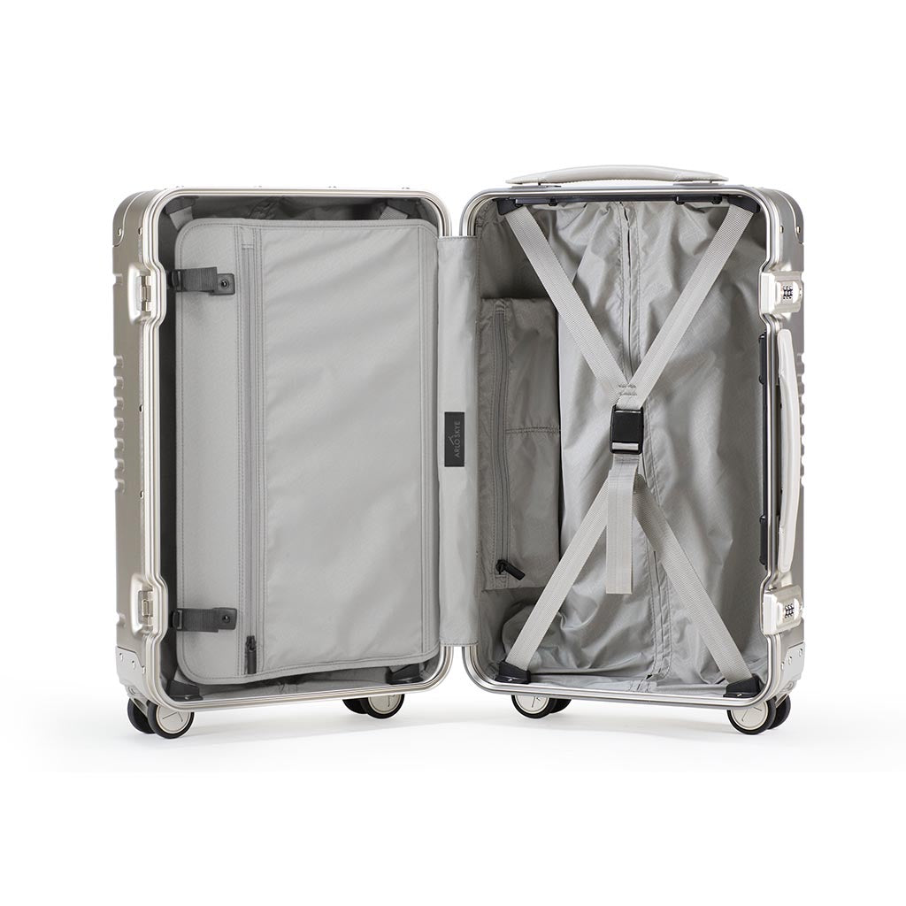 Open frame carry-on in champagne aluminum edition showing the interior of both sides