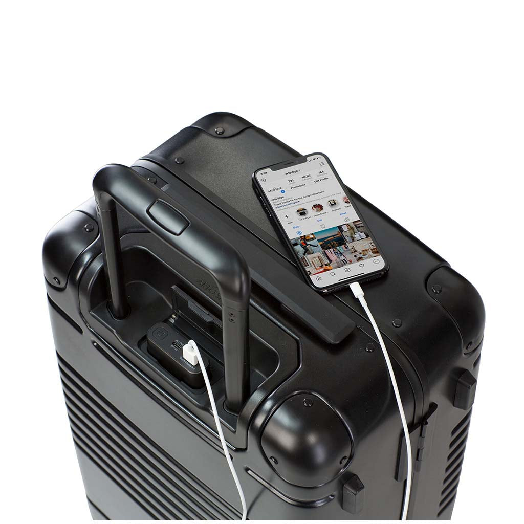 Top down view of frame carry-on max in black showing the spare charger in use