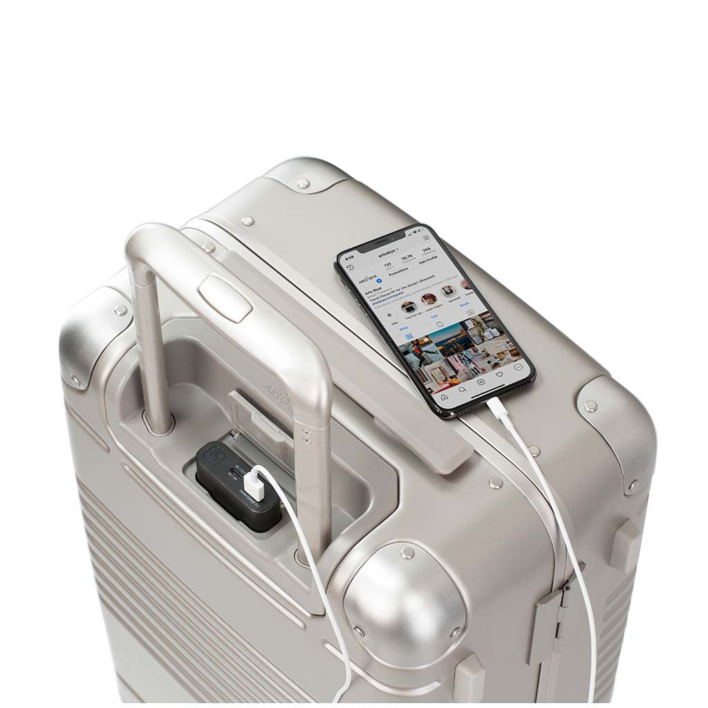 Top down view of frame carry-on max in champagne showing the spare charger in use
