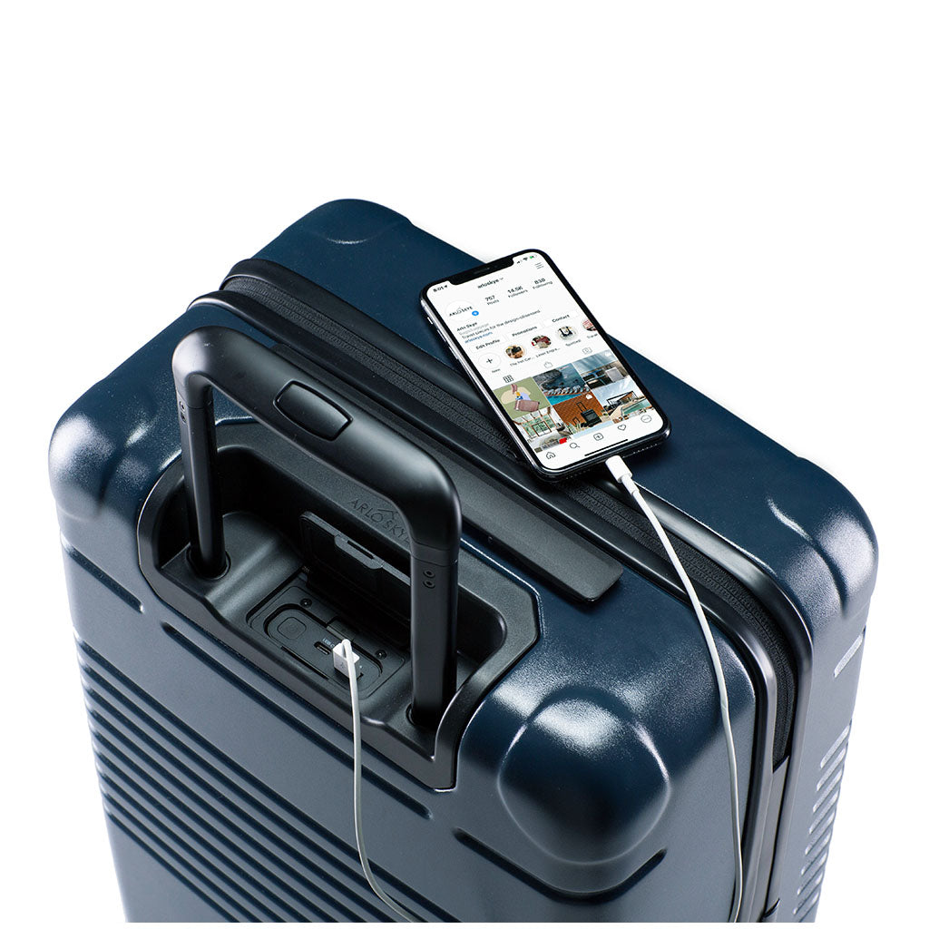 Top view of the zipper carry-on max in navy blue with spare charger in use