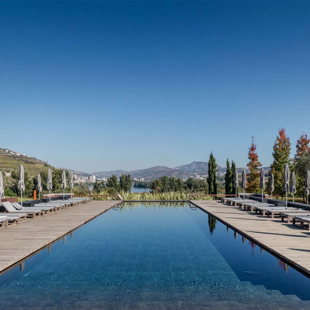 Pool view with Six Senses Duoro Valley in Portugal background