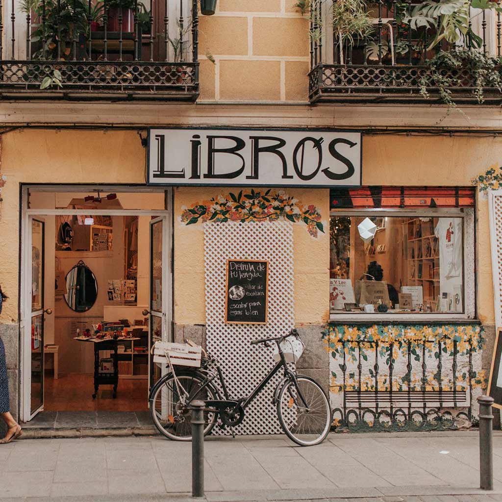 A cafe in Madrid called Libros with bicycle parked outside.