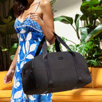 woman holding weekender with hand using the hand straps