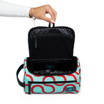 Arc Dopp Kit held open in hand, lifestyle shot