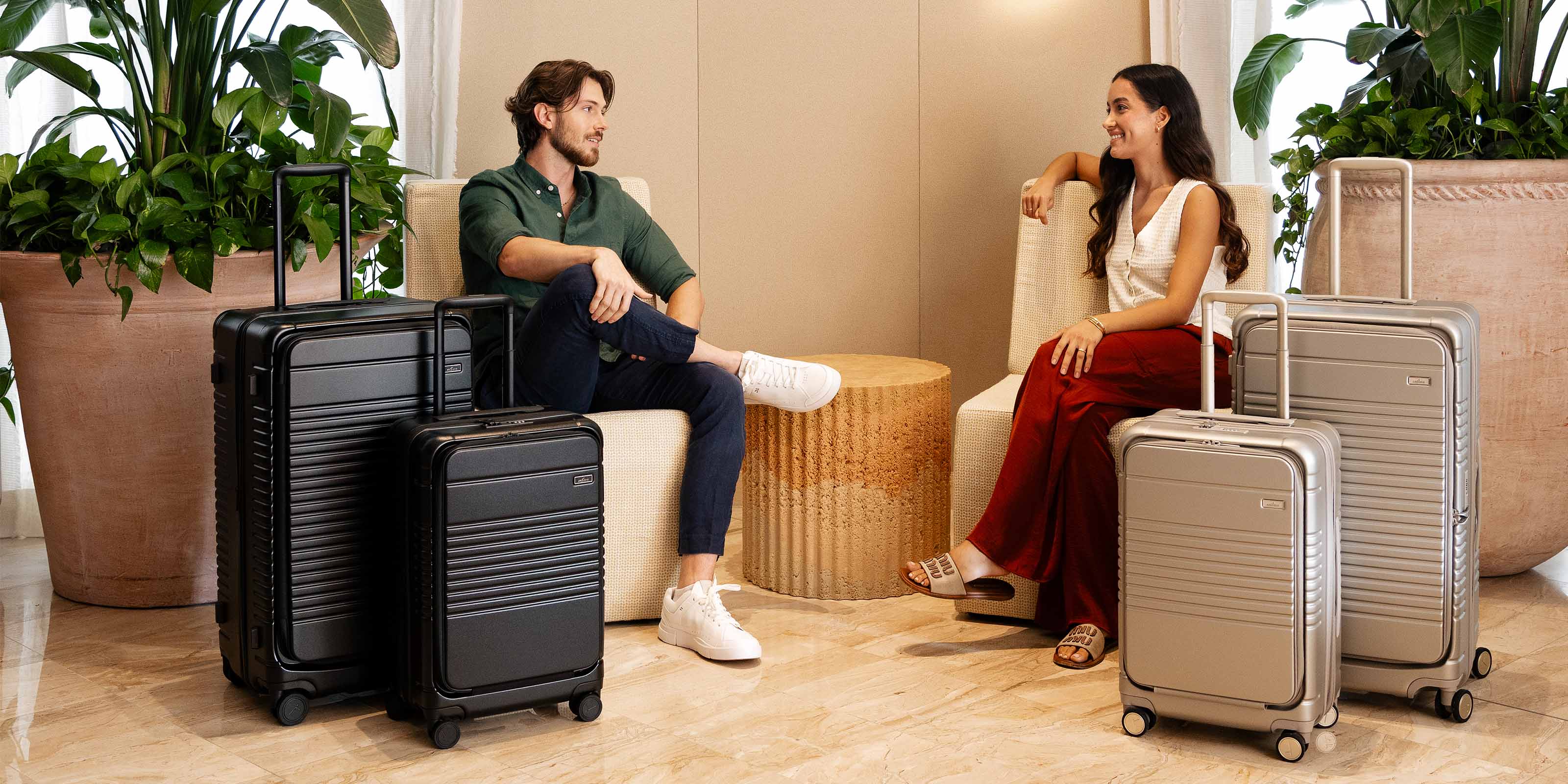 man and woman with luggage by their side