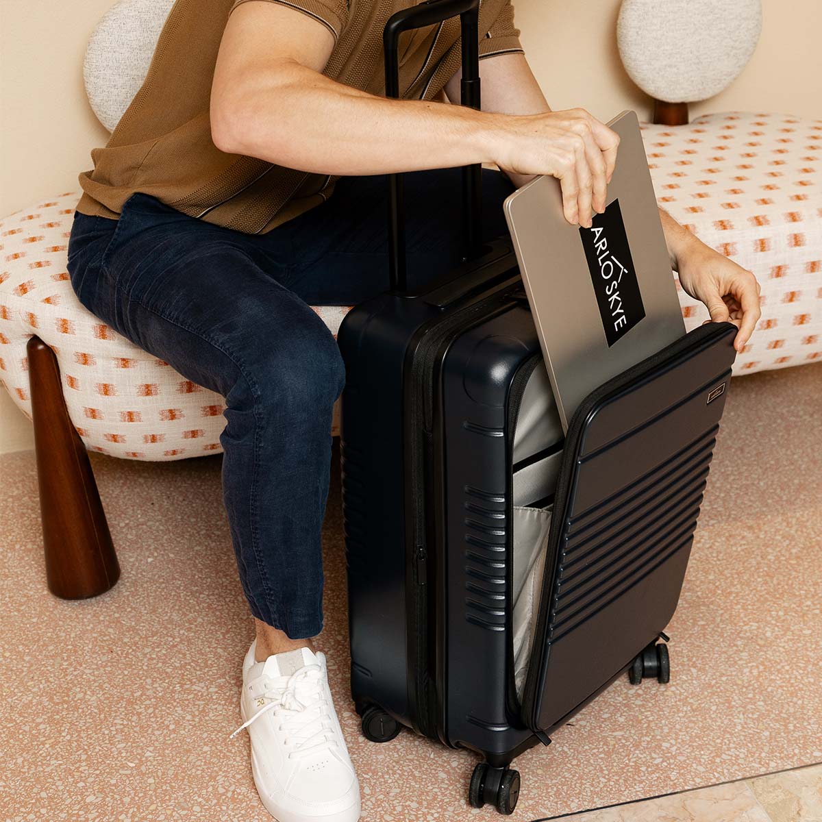 Black expandable carry-on max with the front pocket holding a laptop
