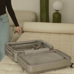 champagne carry-on max with front pocket flat lay view on how to unzip the expandable zipper
