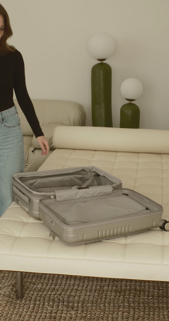 champagne carry-on max with front pocket flat lay view on how to unzip the expandable zipper