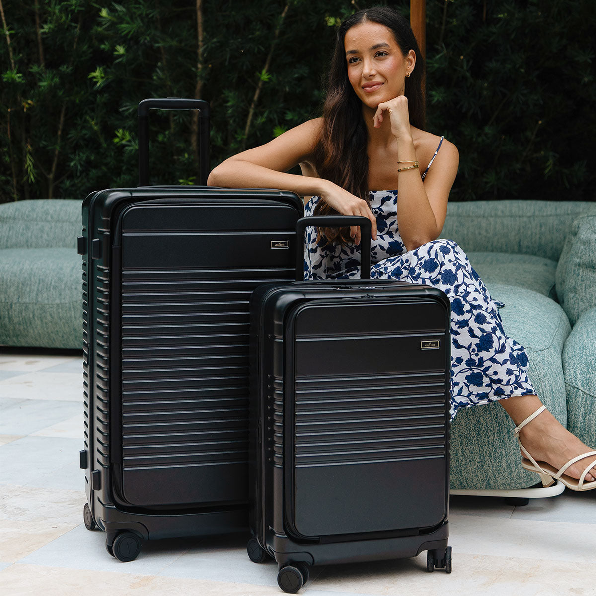lady with trunk and carry-on max next to her.