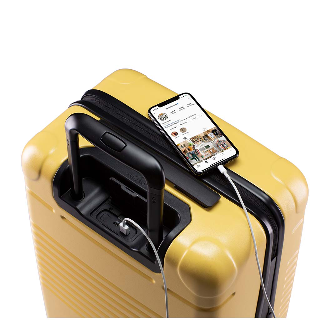 Top view of the zipper carry-on max in yellow with spare charger in use