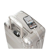 Top down view of frame carry-on max in champagne showing the spare charger in use