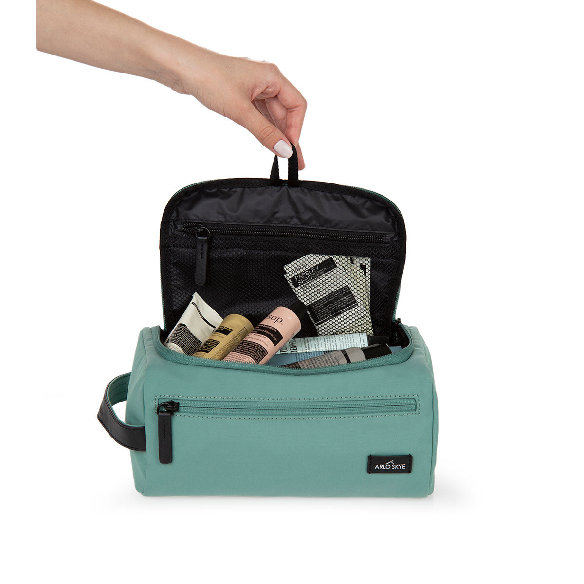 toiletry bag in mint color showing interior view.