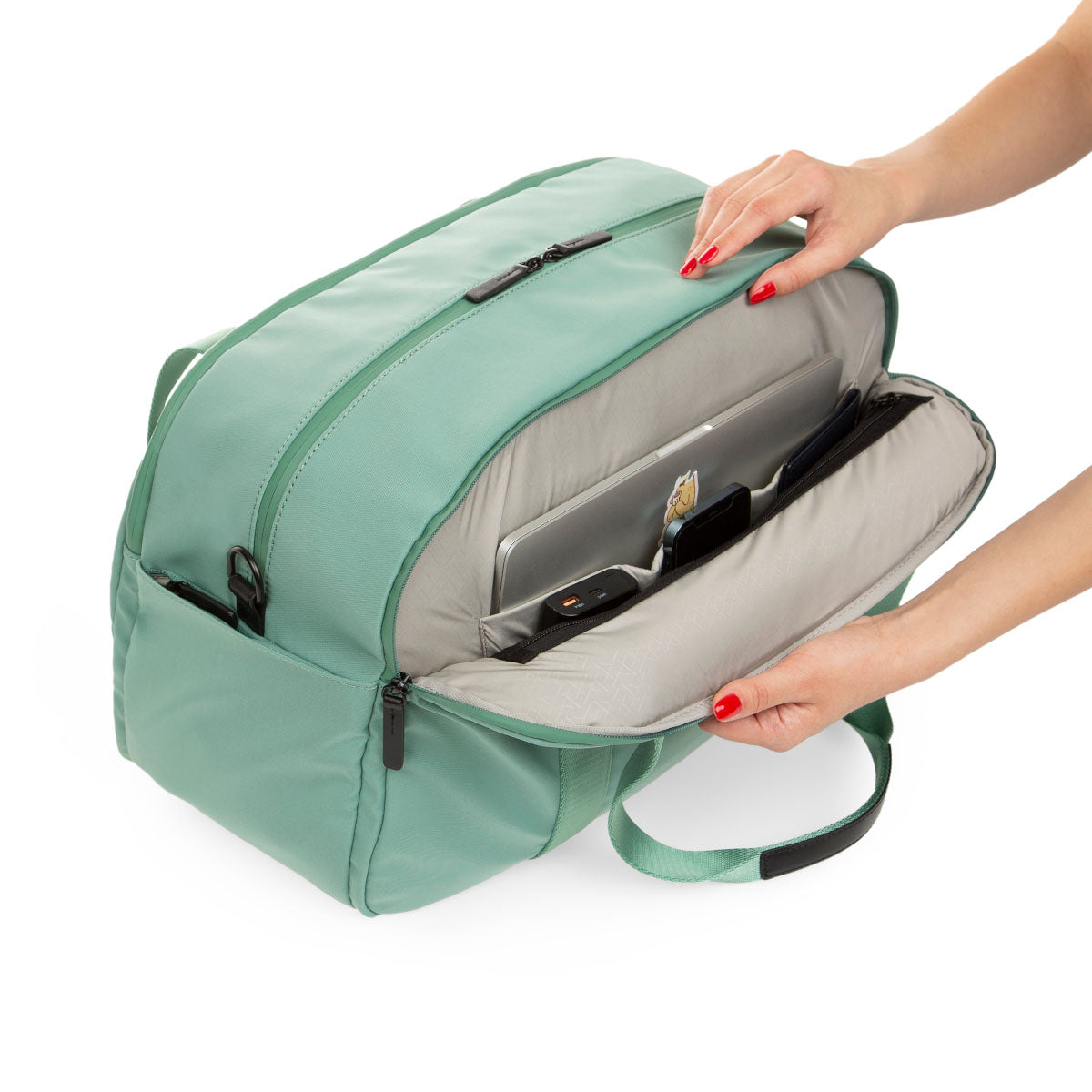 side view of mint weekender with side pocket open showing laptop sleeve inside and three slip pockets for passport type items.